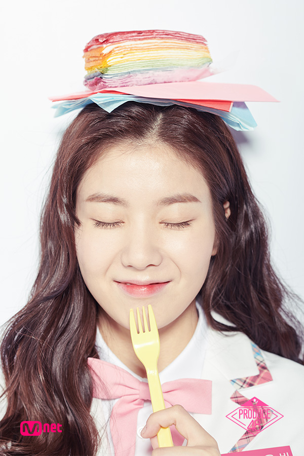 Tags: Television Show, K-Pop, Kwon Eunbi, Eyes Closed, Collar (Clothes), Food, Text: Series Name, Wavy Hair, Holding Object, Bow Tie, White Outerwear, Close Up