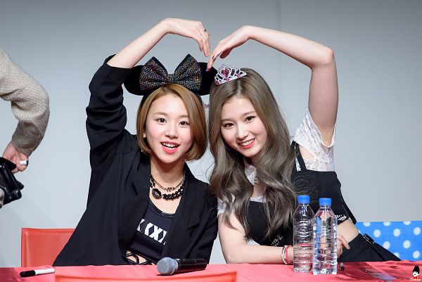 Tags: K-Pop, Twice, Son Chaeyoung, Minatozaki Sana, Hair Bow, Midriff, Crown, Two Girls, Sitting On Chair, Bow, Chair, Heart Gesture